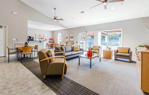 a living room with couches and chairs and a table